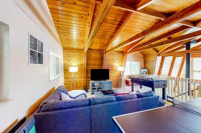 a living room with a couch and a table at Cozy Cabin in Groveland
