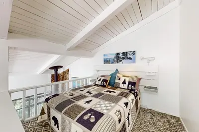 a bedroom with a bed on a balcony at Sunrise Serenity at Tahoe Village in Stateline