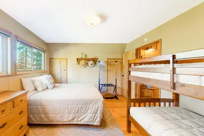 a bedroom with two bunk beds and a desk at Fernwood in Shaver Lake