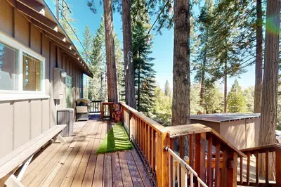 a wooden deck on a house with trees at Fernwood in Shaver Lake