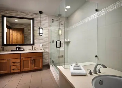 a bathroom with a shower and a sink and a mirror at Hyatt Vacation Club at Northstar Lodge in Truckee