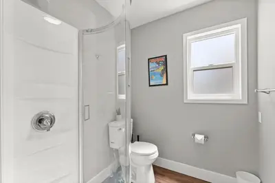a white bathroom with a toilet and a shower at Tranquil Retreat: Cozy 2Bed, 1Bath Oasis in Fallon in Fallon