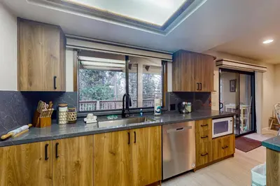 a kitchen with wooden cabinets and a sink at Tranquil Pines Estate in Shaver Lake