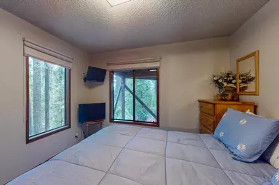 a bedroom with a large bed and a window at Tranquil Pines Estate in Shaver Lake