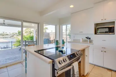 a kitchen with white cabinets and a stove top oven at Discovery Bay Home with On-Site Delta Access! in Discovery Bay