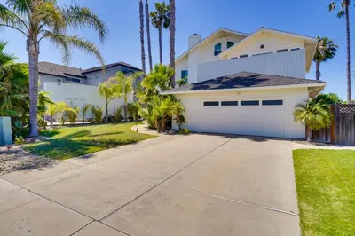 a white house with palm trees and a driveway at Discovery Bay Home with On-Site Delta Access! in Discovery Bay
