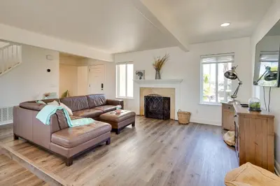 a living room with a couch and a fireplace at Discovery Bay Home with On-Site Delta Access! in Discovery Bay