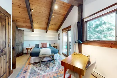 a bedroom with a bed and a wooden ceiling at Pine Haven Retreat in Stateline