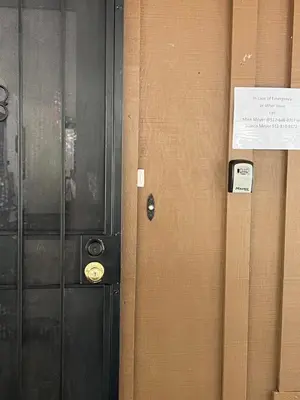 a black door with a sign on it next to a wall at Ponderosa Creekside Retreat in Mariposa