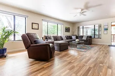 a living room with a couch and a chair at Ponderosa Creekside Retreat in Mariposa