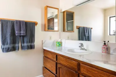 a bathroom with a sink and a mirror at Ponderosa Creekside Retreat in Mariposa