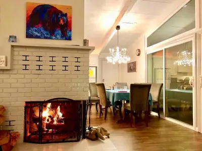 a living room with a fireplace and a dining table at Black Bear Suite Hot Tub Sleeps 4 affordable in Oakhurst