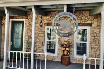 a stone building with a sign in front of it at Black Bear Haven Hot tub Pool table BBQ Darts in Oakhurst