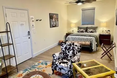 a bedroom with a bed and a couch and a chair at Crazy Cow Private HOT TUB BBQ Sleeps 2 in Ahwahnee
