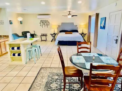 a bedroom with a bed and a table and chairs at Crane Suite Hot Tub Bbq King Bed- Sleeps 4 in Ahwahnee