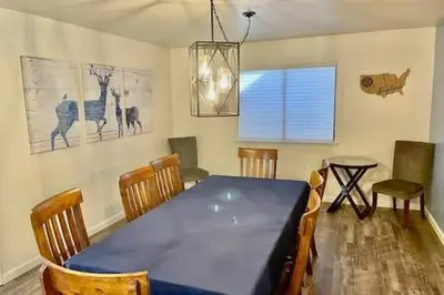a dining room with a blue table and chairs at Deer Suite HOT TUB GAME ROOM SLEEPS 2 in Ahwahnee
