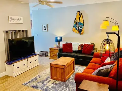 a living room with a couch and a flat screen tv at Eagle Nest River Views Hot Tub Games Sleeps 6 in Ahwahnee