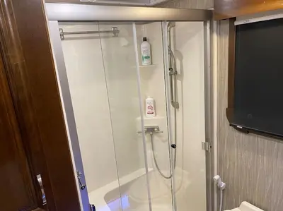 a shower stall in a bathroom with a tv at Happy Hedgehog River Views Hot Tub Private in Ahwahnee