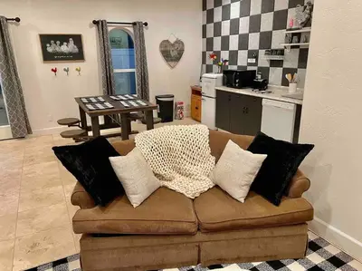 a living room with a couch with pillows on it at The Funky Chicken Hot Tub BBQ SLEEPS 4 in Ahwahnee