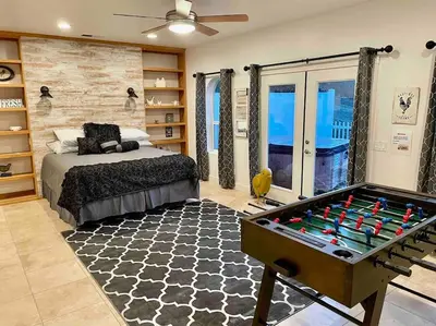 a bedroom with a bed and a pool table at The Funky Chicken Hot Tub BBQ SLEEPS 4 in Ahwahnee