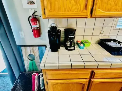 a kitchen counter top with a coffee maker on it at The Lighthouse Pet Friendly Hot Tub BBQ Sleeps 11 in Coarsegold