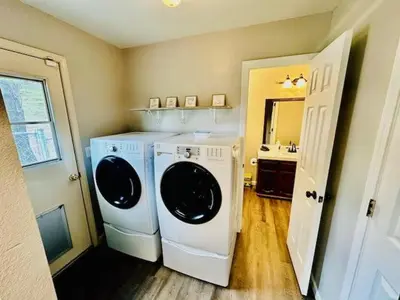 a laundry room with a washer and dryer and a sink at Lighthouse Suite Pet Friendly Hot Tub Sleeps 4 in Coarsegold