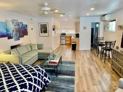 a living room with a bed and a couch and a kitchen at Owl Nest Hot Tub Sleeps 3 Yosemite in Ahwahnee