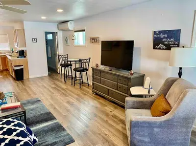 a living room with a couch and a television and a table at Owl Nest Hot Tub Sleeps 3 Yosemite in Ahwahnee