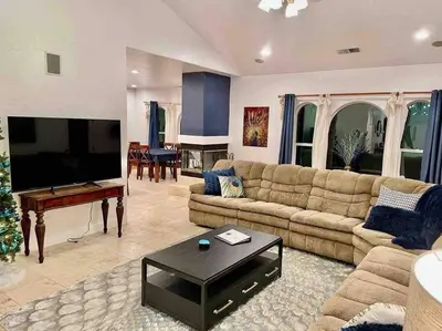 a living room with a couch and a flat screen tv at Peacock Suite Hot Tub Sleeps up to 4 Bbq in Ahwahnee
