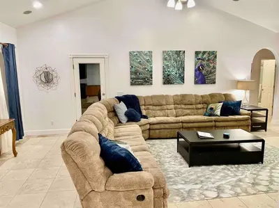 a living room with a couch and a table at Peacock Suite Hot Tub Sleeps up to 4 Bbq in Ahwahnee