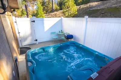 a large blue tub sitting on a patio at Quail Suite HOT TUB BBQ Sleeps 2 in Ahwahnee