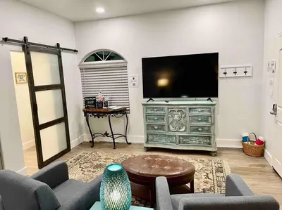 a living room with a large flat screen tv at Quail Suite HOT TUB BBQ Sleeps 2 in Ahwahnee