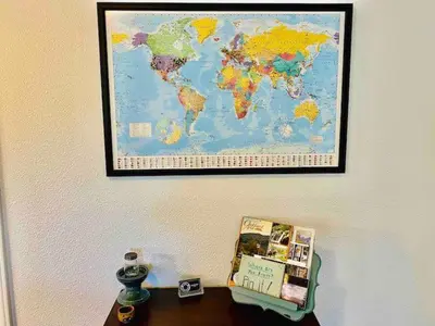 a map of the world hanging on a wall at Raccoon Hideout Hot Tub BBQ Arcade Darts in Oakhurst