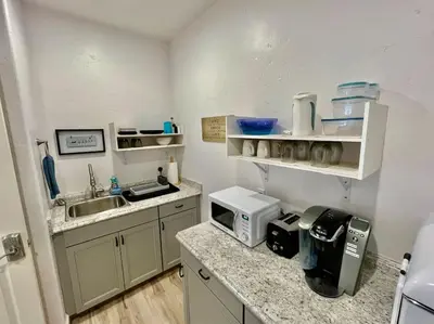 a small kitchen with a sink and a microwave at White Feather Suite Hot Tub Private Sleeps 2 in Ahwahnee