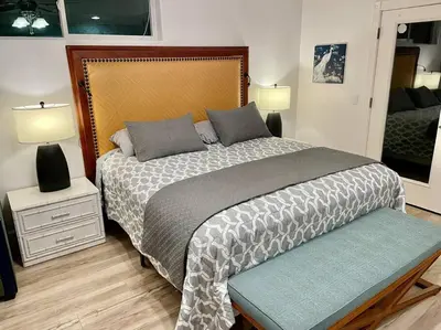 a bedroom with a large bed and two lamps at White Feather Suite Hot Tub Private Sleeps 2 in Ahwahnee
