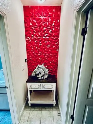 a room with a red wall with a cat sitting on a table at Wild Stallion HOT TUB Sleeps 4 Darts Private in Ahwahnee