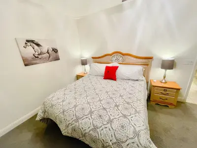 a bedroom with a bed with a red pillow on it at Wild Stallion HOT TUB Sleeps 4 Darts Private in Ahwahnee