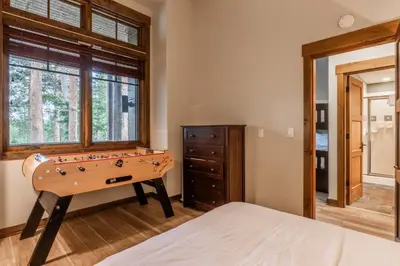 a bedroom with a pool table and a bed at Woodwinds 32 in Mammoth Lakes