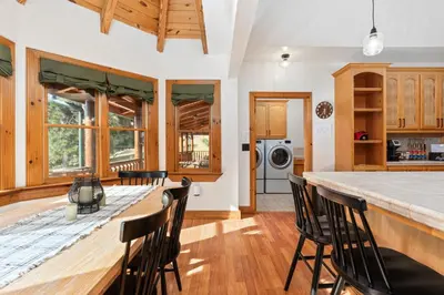 a kitchen with a large wooden table and chairs at Yosemite Villa - log cabin with spectacular views & stargazing in Mariposa