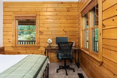 a bedroom with a desk with a computer and a chair at Yosemite Villa - log cabin with spectacular views & stargazing in Mariposa