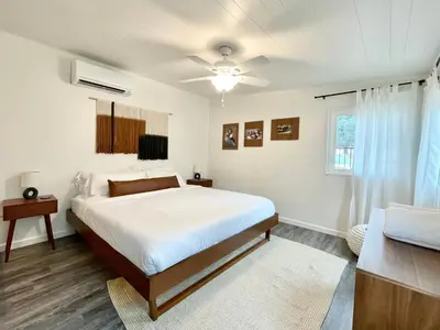 a white bedroom with a bed and a window at Peaceful Mariposa Home near Yosemite National Park in Mariposa