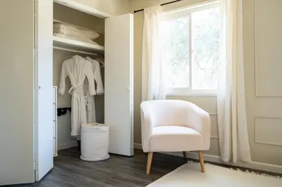 a white chair in a room with a window at Peaceful Mariposa Home near Yosemite National Park in Mariposa