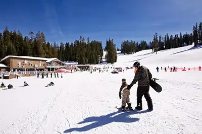 a man and a child standing in the snow at Yosemite Mountain Retreat in Oakhurst