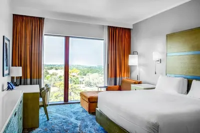 a hotel room with a bed and a large window at Red Hawk Resort & Casino in Placerville