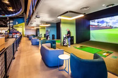 a lobby with chairs and a large screen with a baseball game at Red Hawk Resort & Casino in Placerville