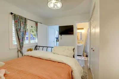 a bedroom with a bed with an orange blanket at Hot Tub and Grill Pet-Friendly Apt, Walk to Midtown in Reno
