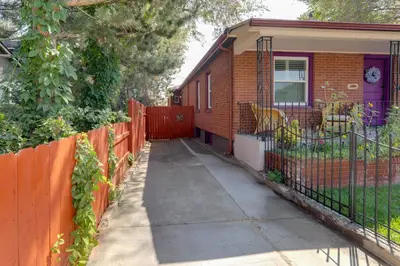 a house with an orange fence next to a sidewalk at Hot Tub and Grill Pet-Friendly Apt, Walk to Midtown in Reno