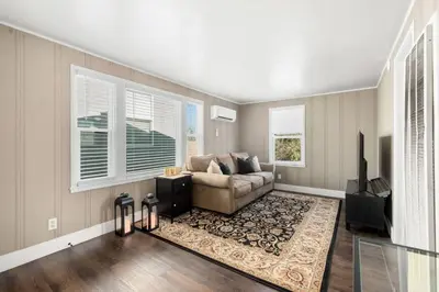 a living room with a couch and a television at Cozy 1bdr/1br home near downtown in Sacramento