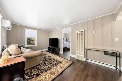 a living room with a couch and a television at Cozy 1bdr/1br home near downtown in Sacramento