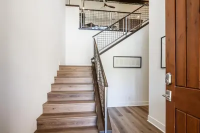 a staircase in a home with white walls and wooden floors at Creekhouse 1583 in Mammoth Lakes